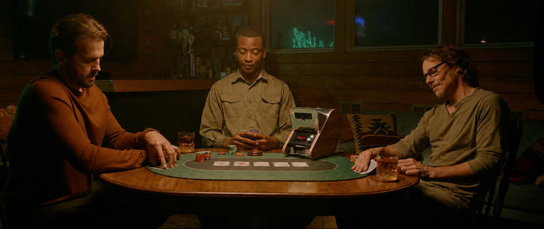 Three players at a card table with LeShuffler dealing